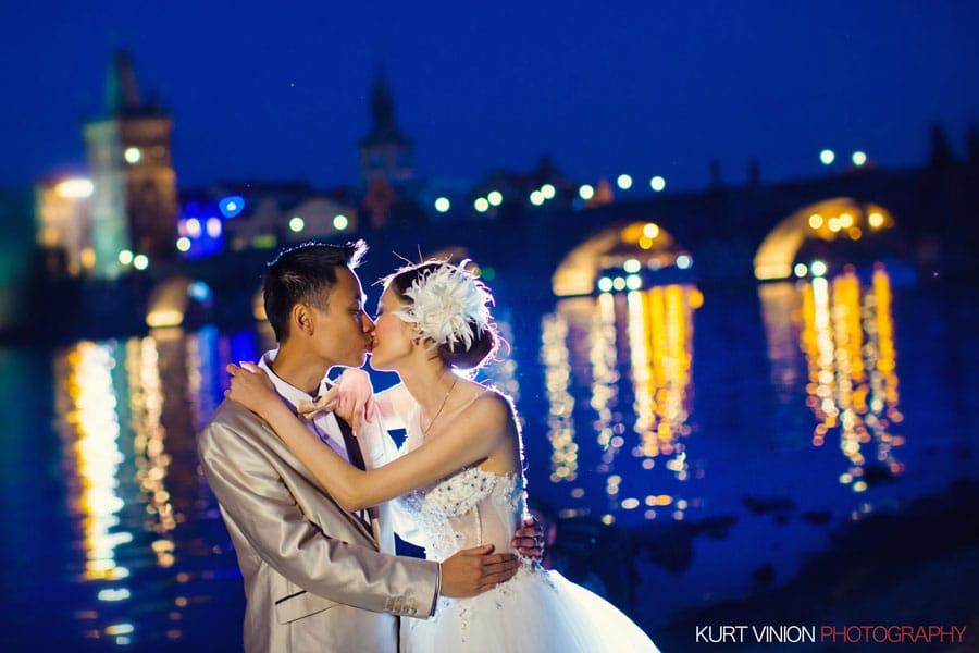 Charles Bridge at night, blue sky, romantic couple kiss, stylish hair piece