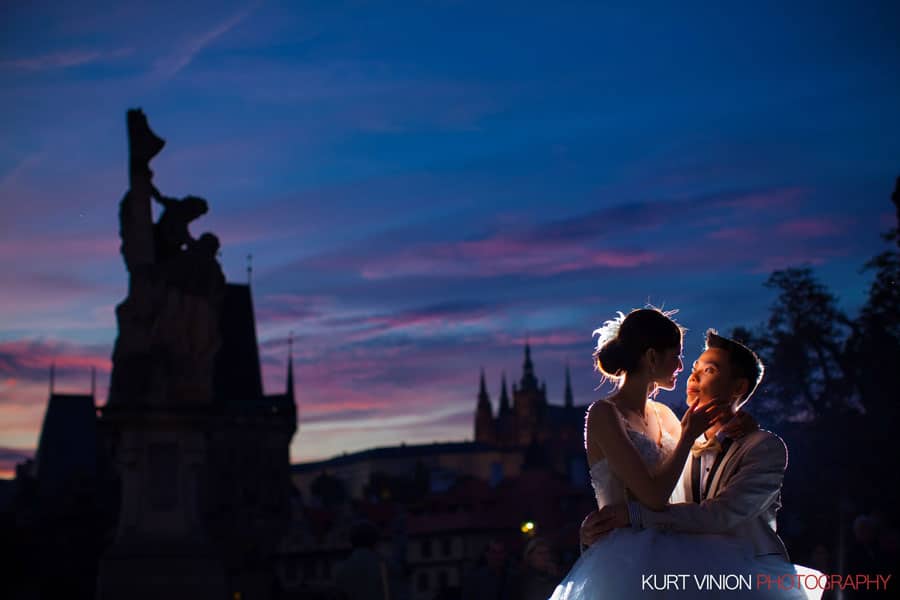 flaring blue & pink sky, Charles Bridge, Prague Castle, rim light of romantic couple, stylish clothes