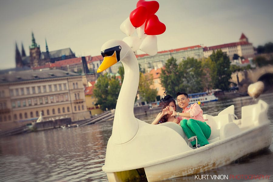 stylish couple, duck boat on river, Prague Castle, green pants, young couple