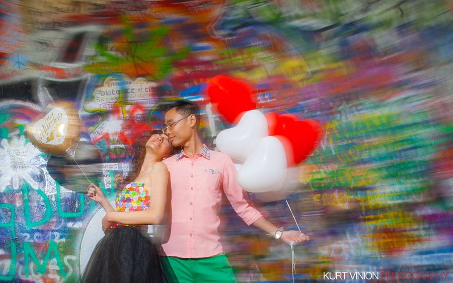 John Lennon Wall, young couple, designer dress, red & white balloons, camera blur, artistic photo