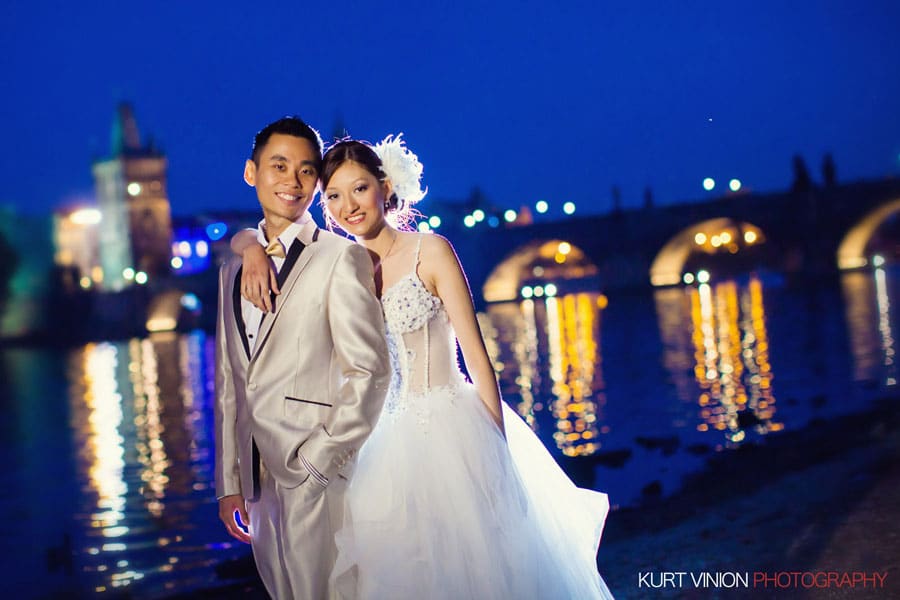 good looking couple, embracing, night portrait, Charles Bridge, blue sky, wedding dress