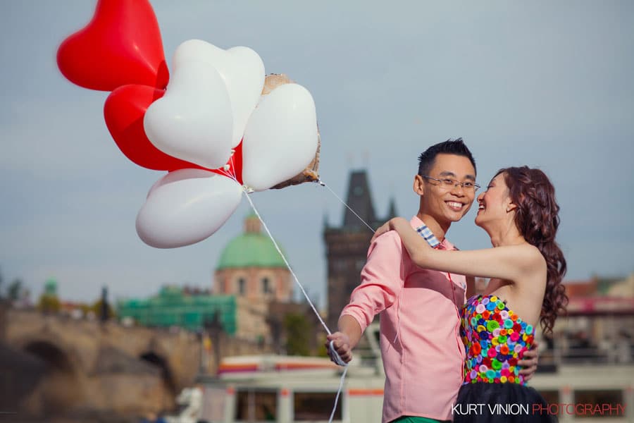 good looking couple, embracing, red & white balloons, laughing, Prague