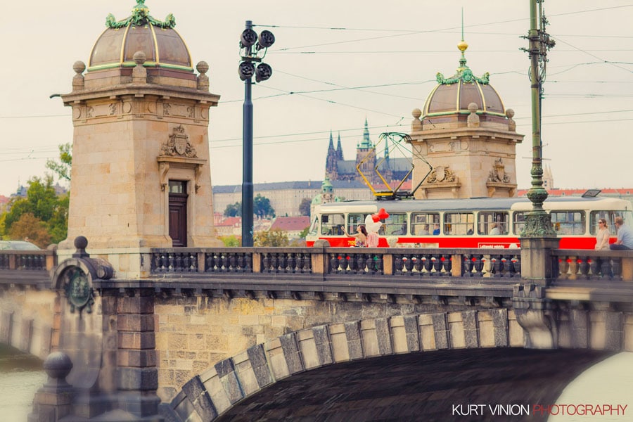 good looking couple, walking near trams, red & white balloons, Prague, bridge