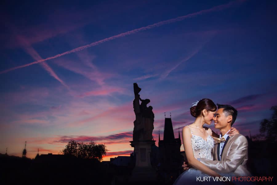 good looking happy couple, flaring night sky, Prague Charles Bridge