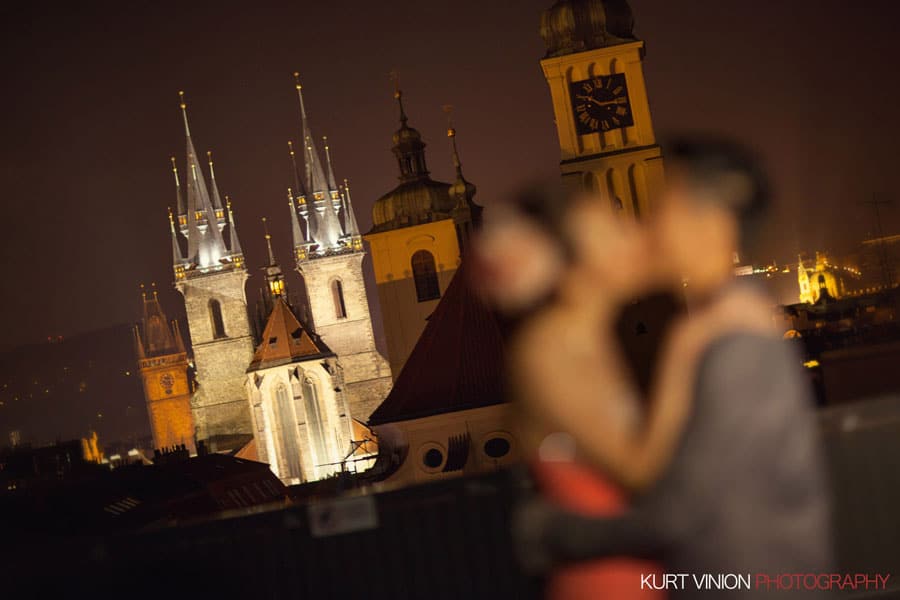lovers embrace, hands on face, designer clothes, night time portrait, Prague skyline