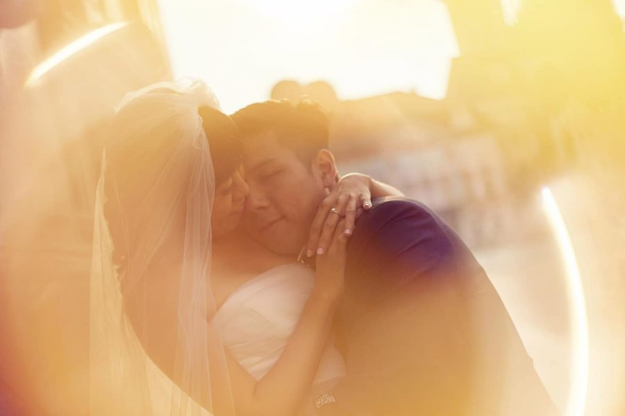Prague Old Town Square, wedding couple, sun flare, couple embracing, yellow