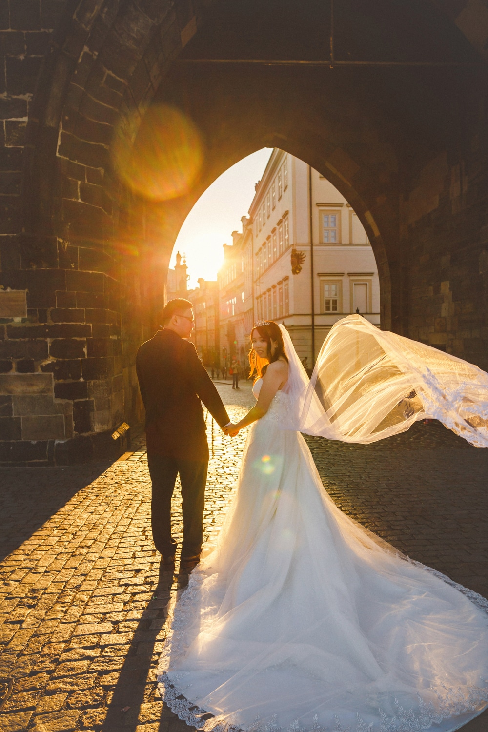 Prague, Charles Bridge, couple portrait, wedding dress, sun flare, Powder Tower