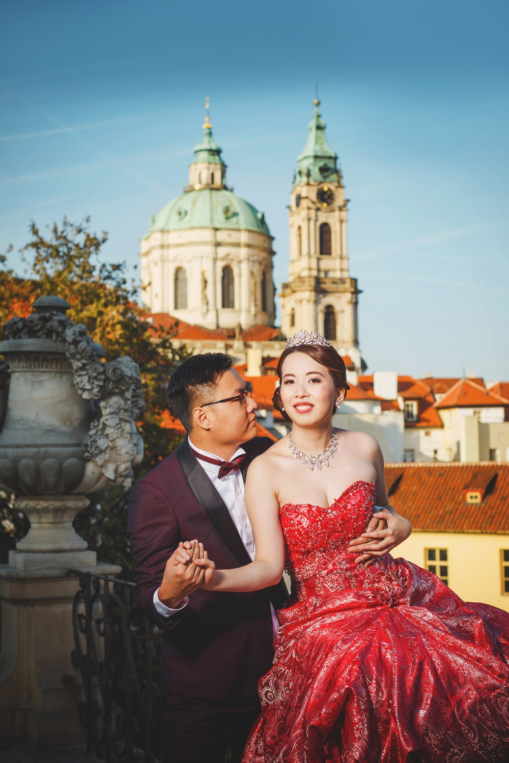 Prague Vrtba Garden, St. Nicholas Church, red dress, young couple embracing, holding hands