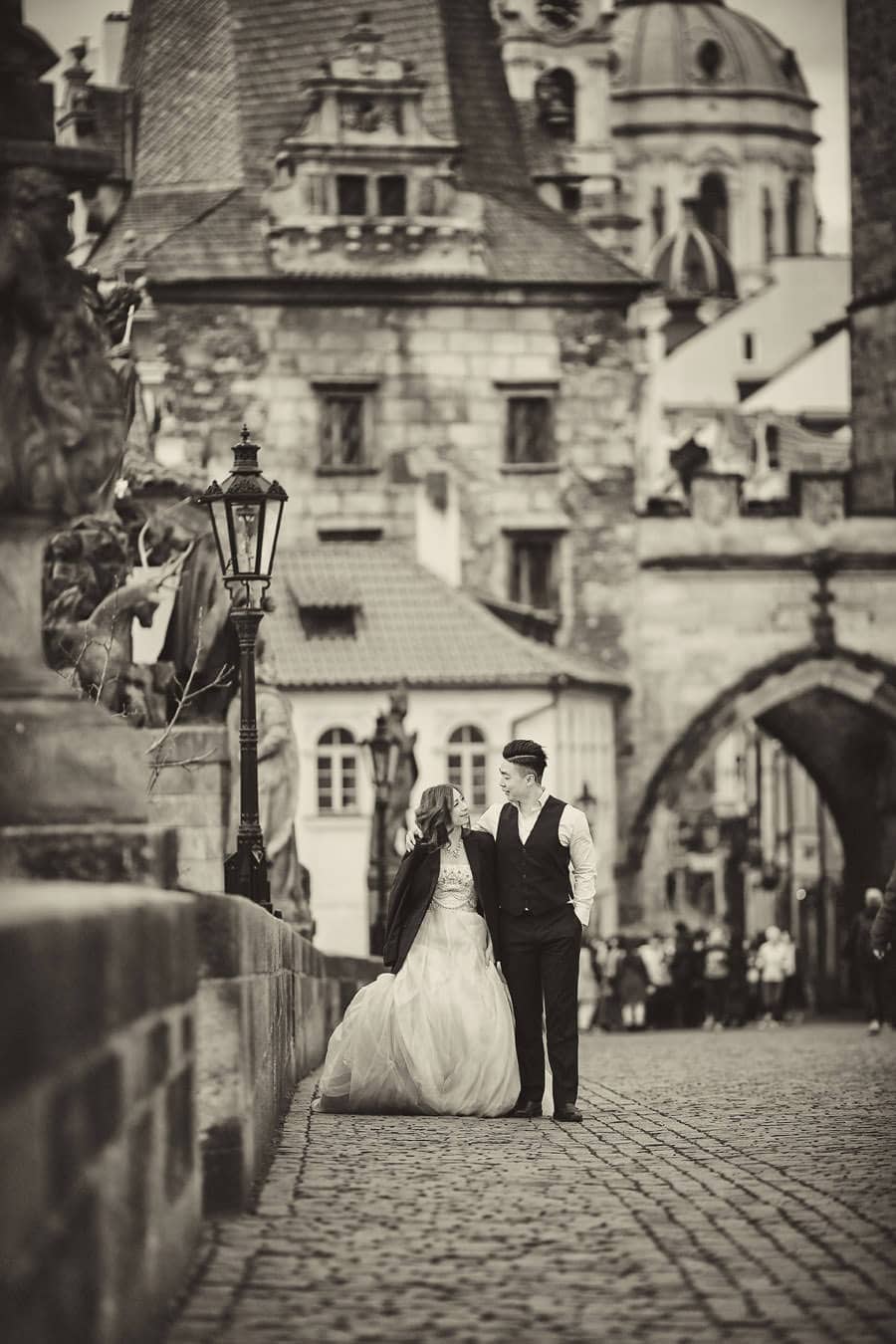 A B&W photo captured at the Charles Bridge in Prague - a Love Story Engagement photo shoot with Tina & Mike