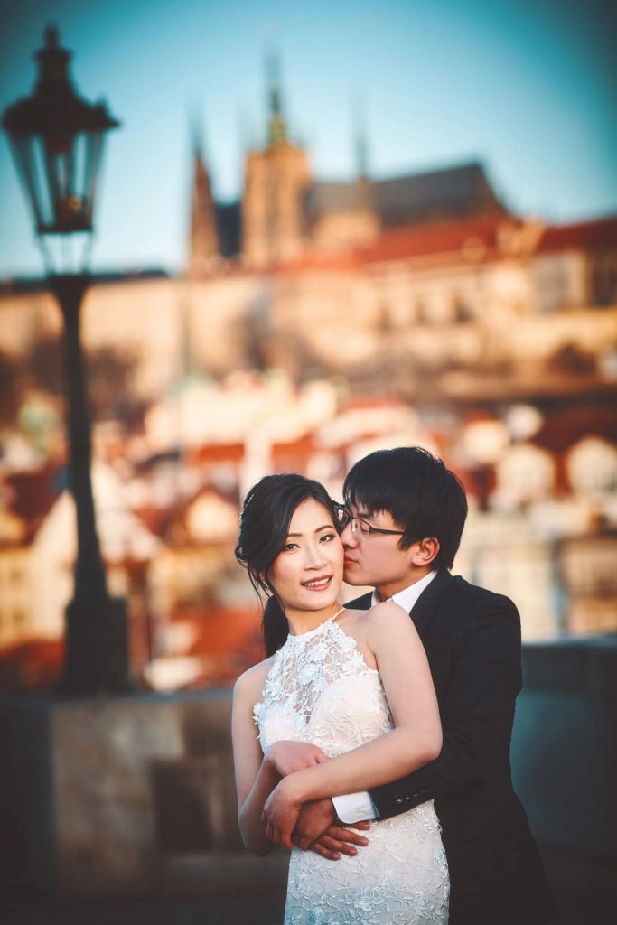 A kiss for the bride-to-be during their sunrise Charles Bridge during their pre-wedding photo shoot.
