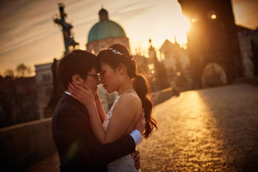 A simple embrace as the sun breaks across the early morning sky above the Charles Bridge Powder tower. 