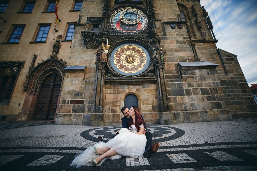 bride & groom under Astronomical Clock in Prague
