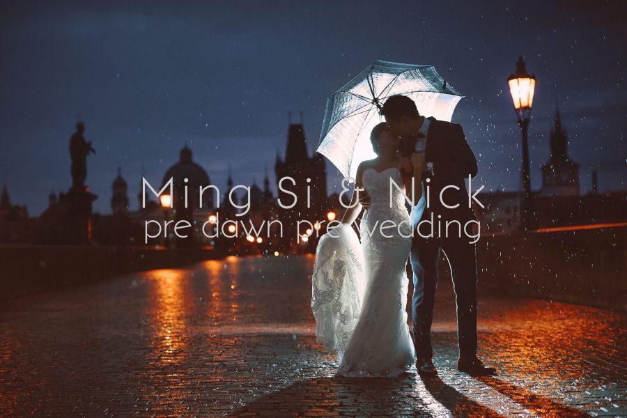 pre wedding couple in the rain on the Charles Bridge at night